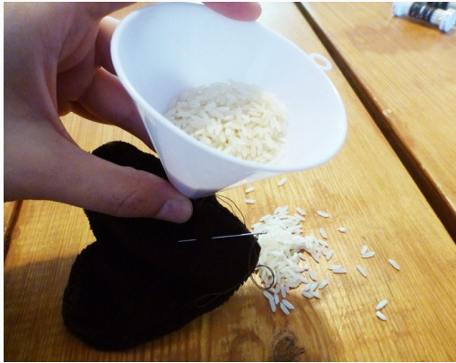 Pouring rice into the handwarmer