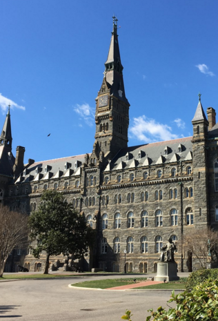 Healy Hall, a national historical landmark, located in front of the main entrance, Healy Gates. A statue of Bishop John Caroll, founder of Georgetown University, is seen center. Photo by Kyle Hammalian.