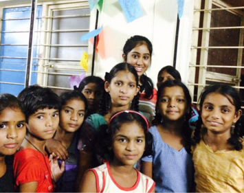 Harika Vasireddy behind girls at Rainbow Homes Orphanage in Secunderabad, India.