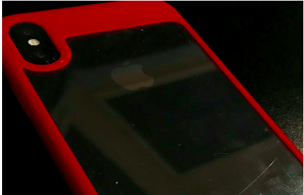 A photo of the classic black iPhone X with a red protective case