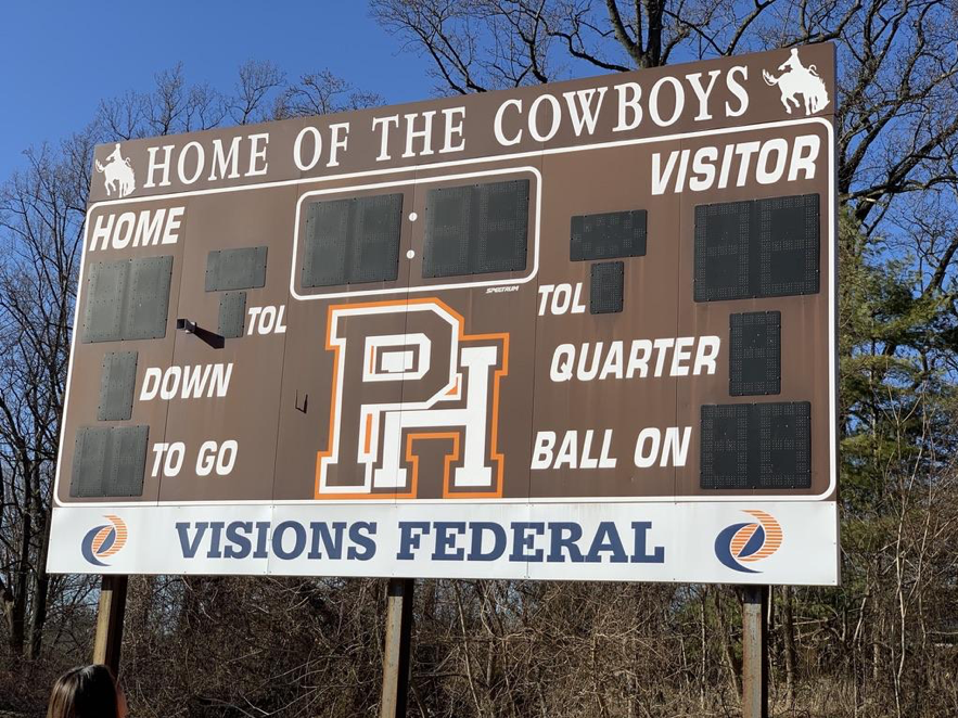 The football scoreboard on Pascack Hills field. The top of the board reads Home of the Cowboys.