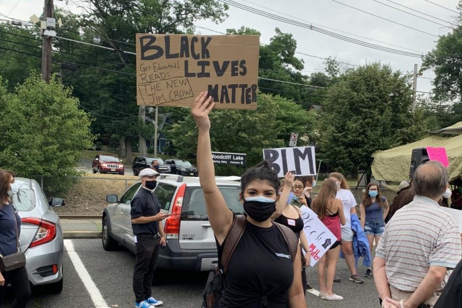 A protester holds a sign at the racial equity rally in Woodcliff Lake.