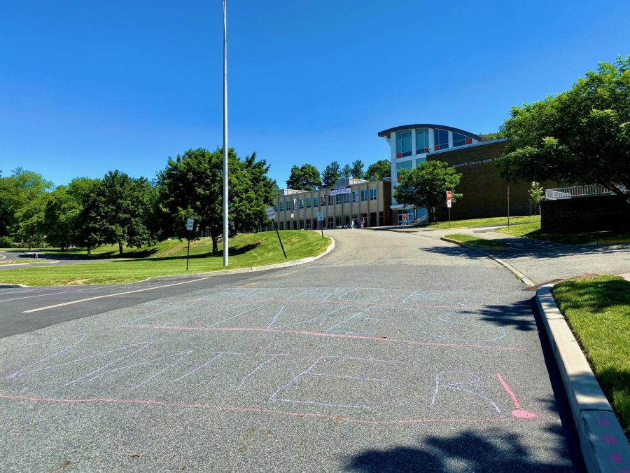 Students write the names of Black Americans killed by police brutality in parking lot spaces on Hills campus. The protest was planned by members of the Hills-Valley equity team.