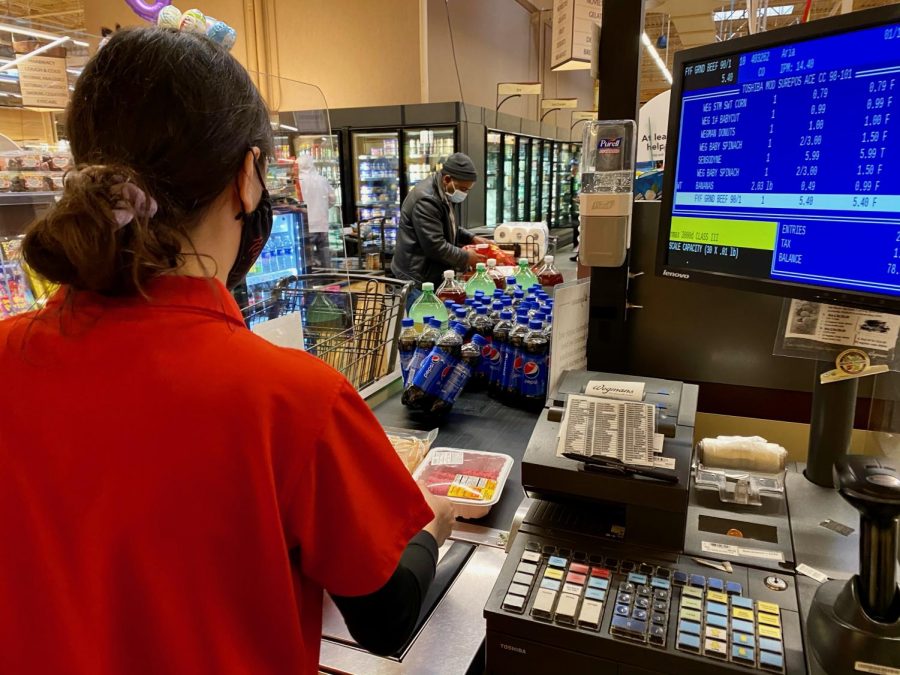 Aria Chalileh, pictured here checking out a customer, is a Hills senior who works part-time as a cashier at Wegmans.