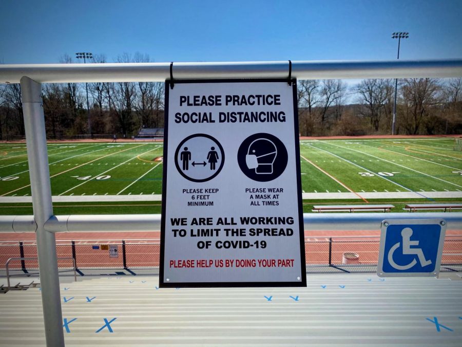 Signage on the bleachers at Hills reminding spectators to wear masks and social distance.