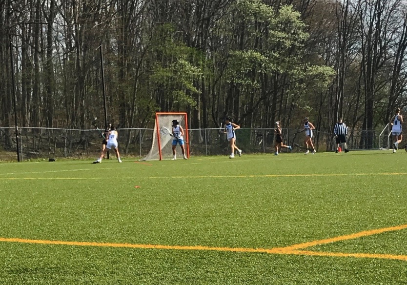 The+first+game+of+the+season+at+Morris+Catholic+High+School.+Junior+Ally+Green+and+sophomore+Emily+Sailer+are+pictured%3B+Green+is+in+possession+of+the+ball.+Hills+players+are+dressed+in+brown.