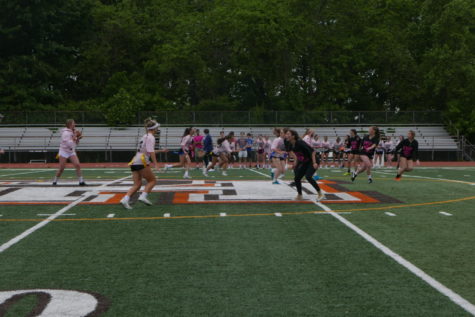 The juniors (in the pink uniforms) and seniors (in the black uniforms) competing against each other in Powder Puff.