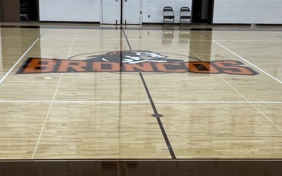 The new logo on the floor in the center of the main gym.