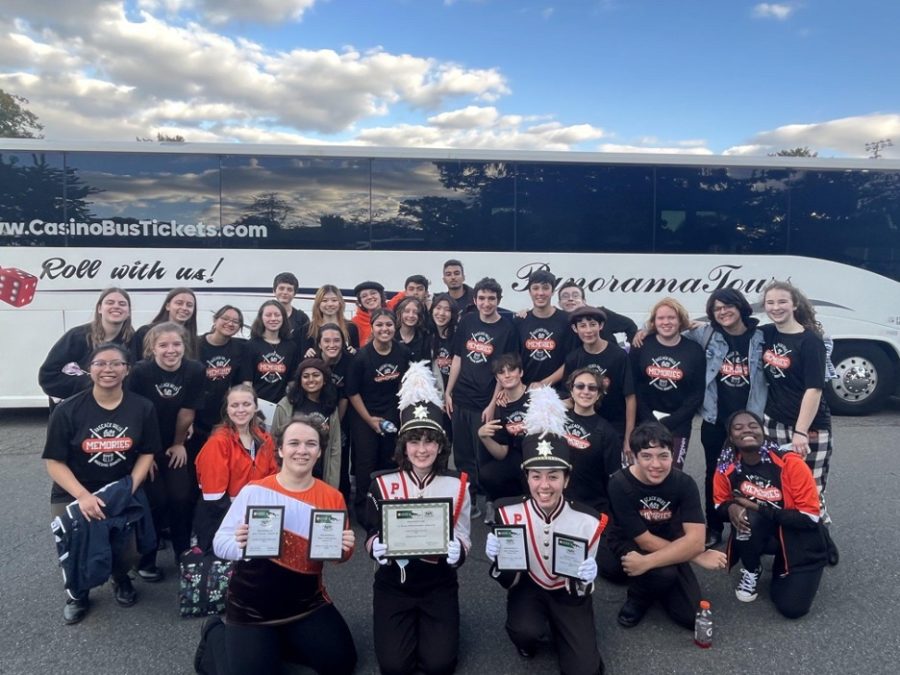 Members of the band pose for a photo after the competition with their awards.