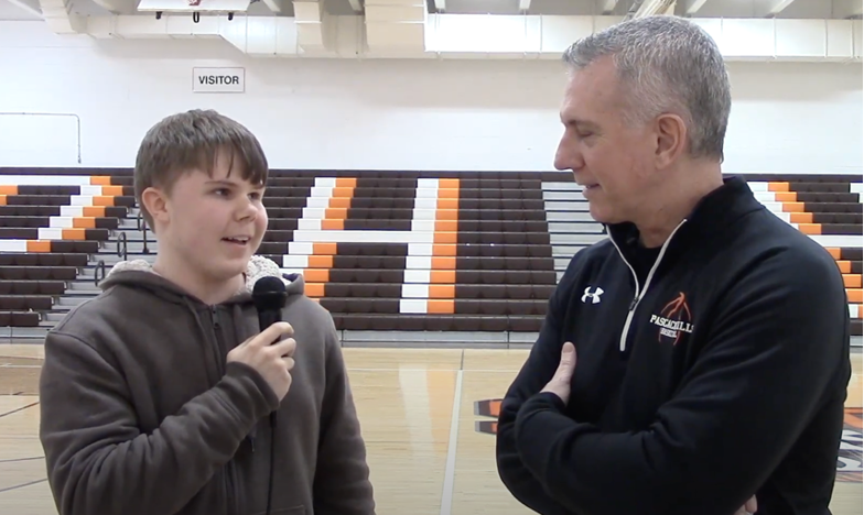 Merlino (left) interviewing the boys varsity basketball coach, Paul D’Errico (right). 