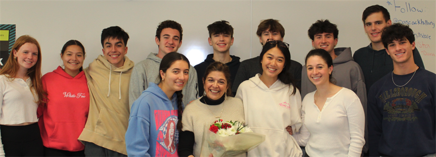 Corin Gamgort (center) receiving flowers with her students. 