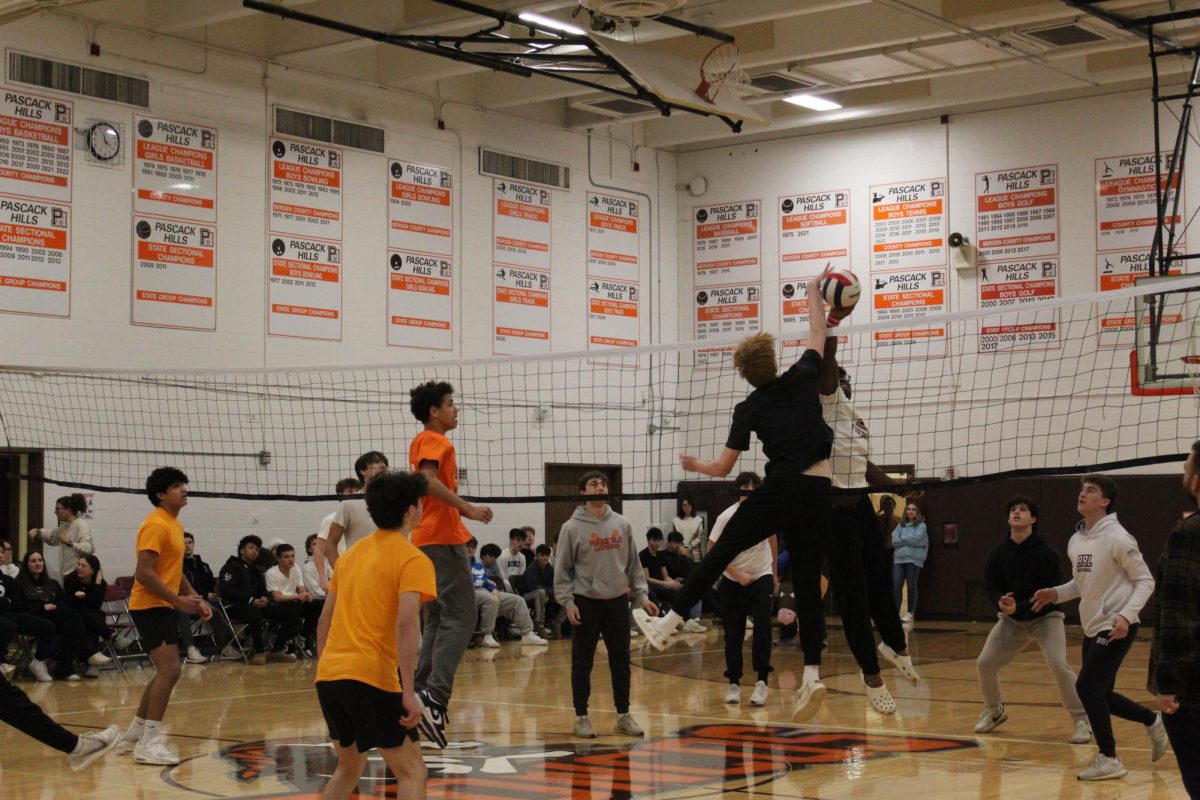 The sophomores (left) and juniors at tip-off in volleyball. 