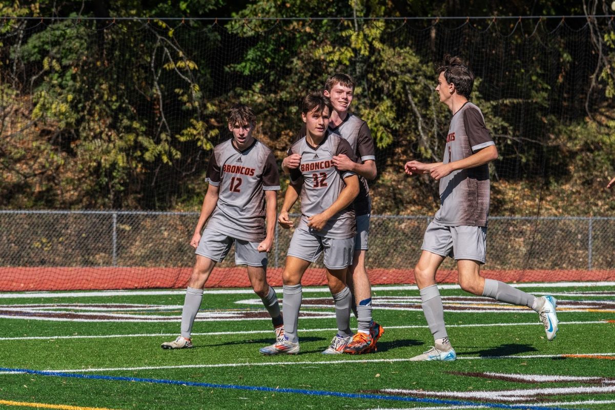 The boys soccer team celebrates Logan Nassau’s goal against Bergen Charter.