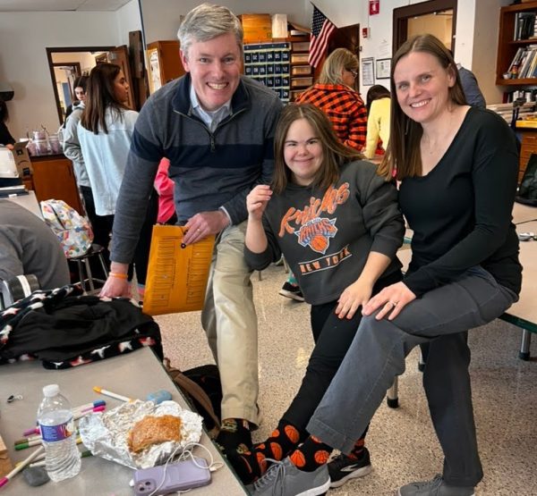 Eva Martinez (middle) wearing socks in honor of Joe McNeice.