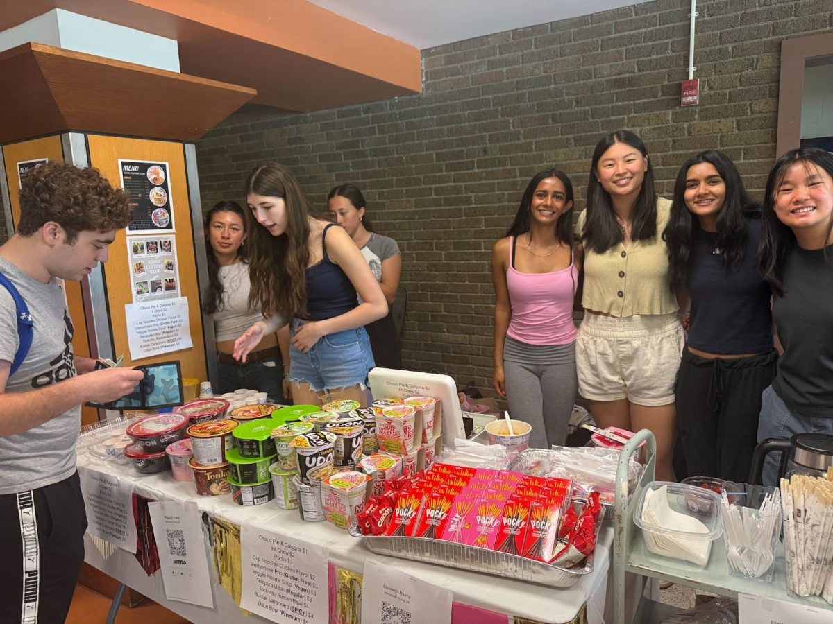 Students buying and selling cultural foods.