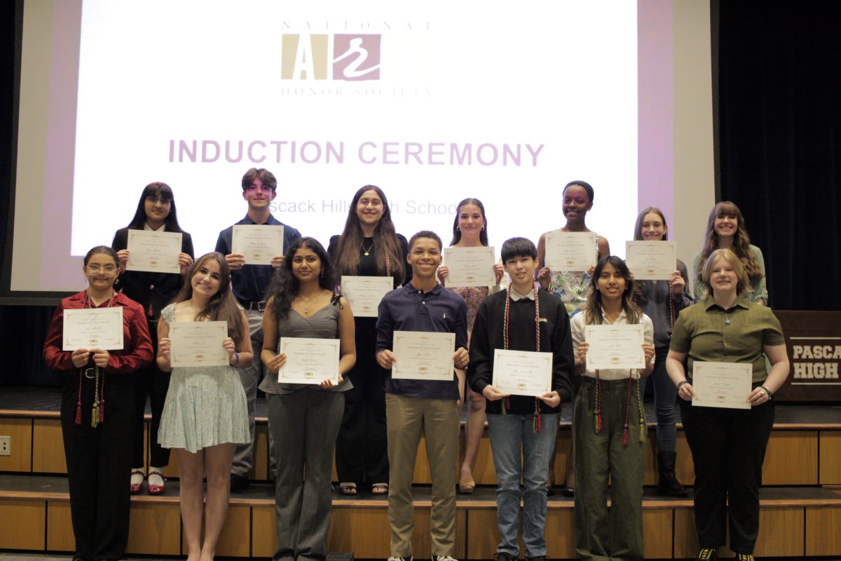 Inductees smiling with their certificates.