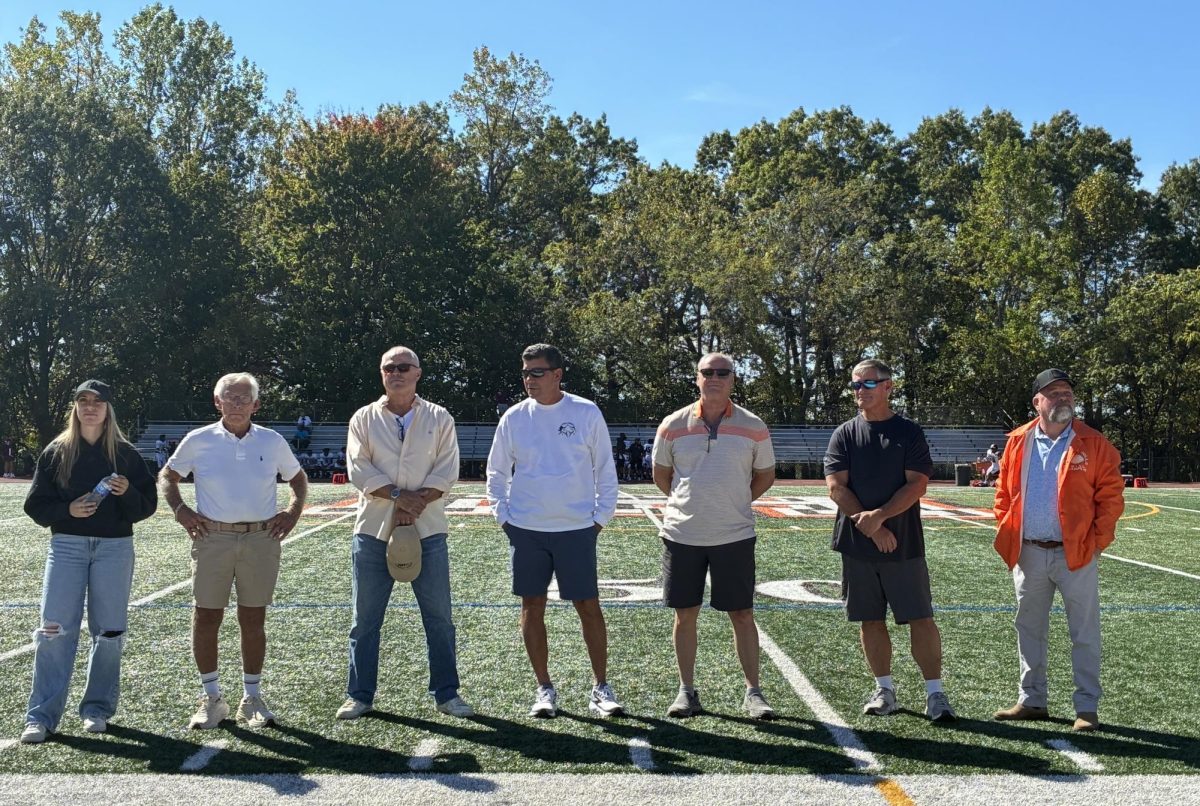 Hall of Fame inductees standing on the Pascack Hills Football Field.