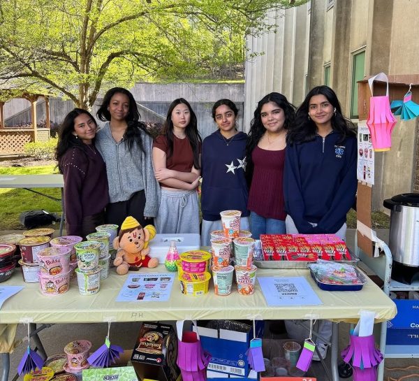 The Asian Culture Club poses for a picture at its stand. Photo taken by Jane Yeam.  