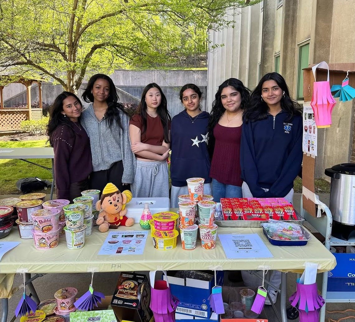The Asian Culture Club poses for a picture at its stand. Photo taken by Jane Yeam.  